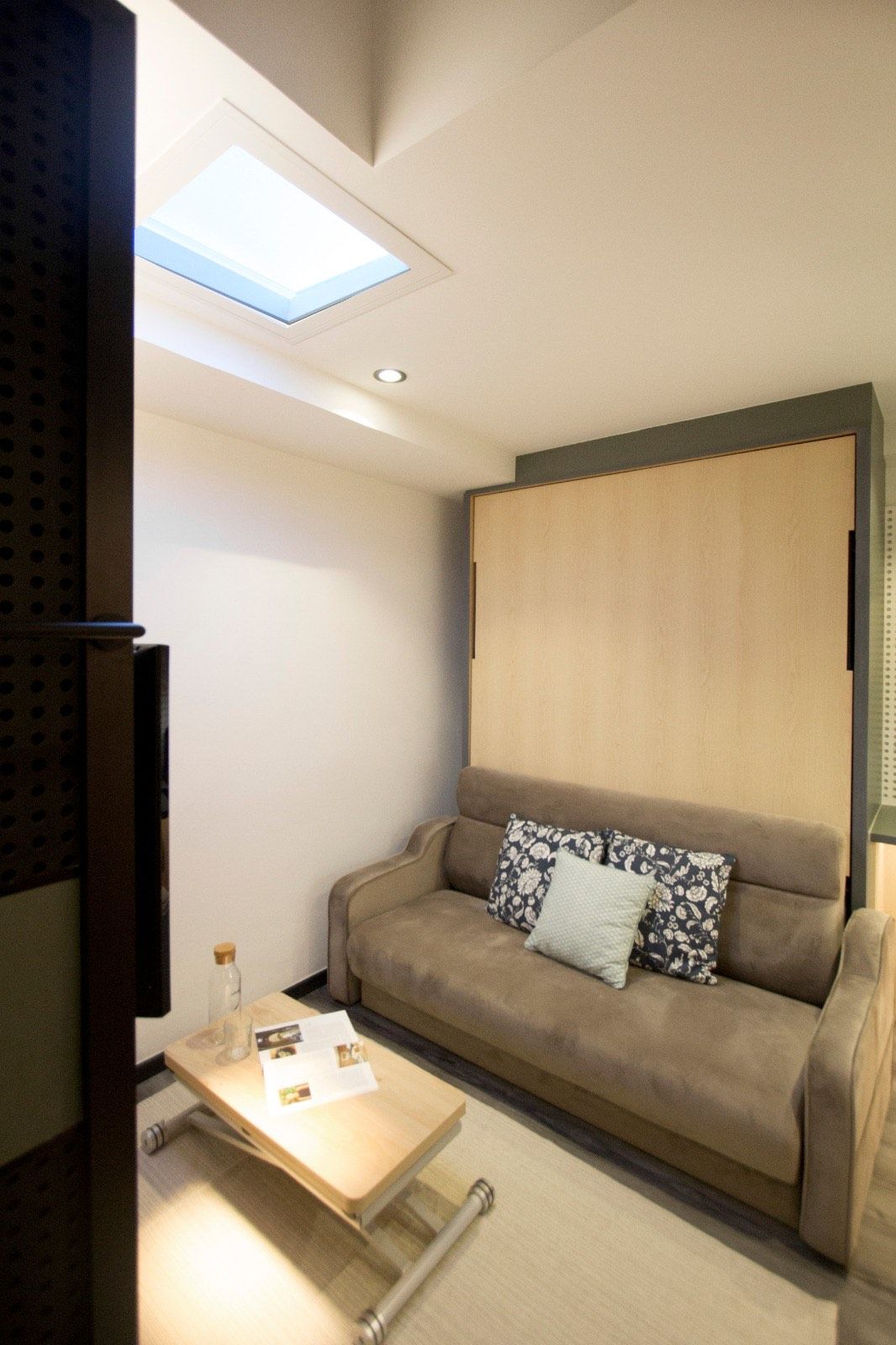 Artificial skylight above a compact apartment living nook